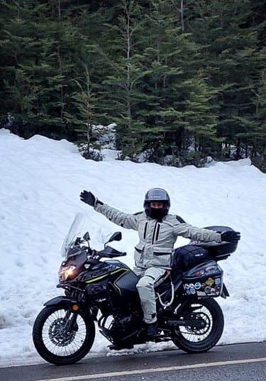 a man in a white jacket and helmet on a motorcycle